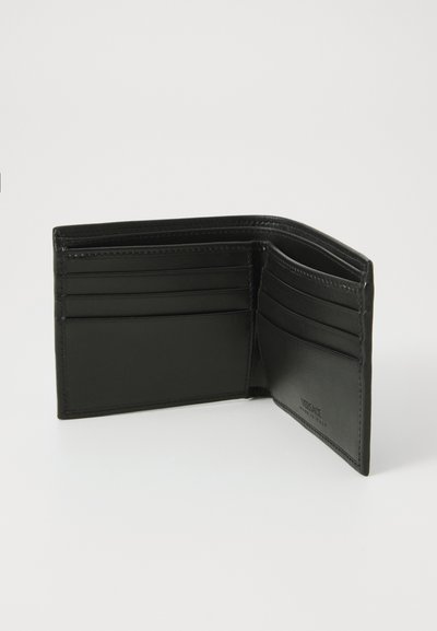 Black leather wallet with multiple card slots, smooth exterior, and embossed "VERSACE" logo. Opened view showing interior layout.