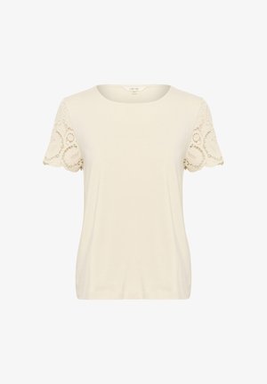 Kreminė marškinėlė su apvaliu iškirpimu ir trumpomis rankovėmis. Rankovės puošia sudėtinga nėrinių detalizė. Minkšta, lygi medžiaga ir laisvas siluetas.