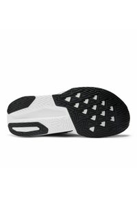 Semelle de chaussure avec un schéma de couleurs noir et blanc. Caoutchouc texturé avec des motifs triangulaires pour l'adhérence et la stabilité. Design de talon arrondi.