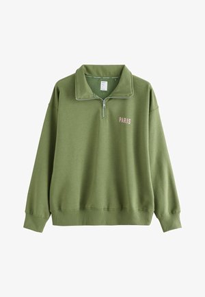 Alyvuogių žalios spalvos džemperis su pusiau užtrauktuku ant kaklo. Frontinėje dalyje yra „PARIS“ užrašas šviesiai rožine spalva. Pagamintas iš minkštos, tekstūruotos medžiagos.