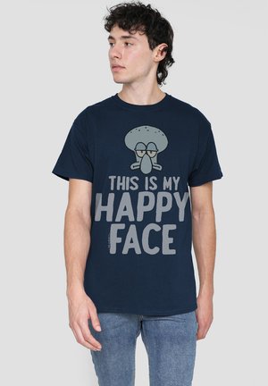 Navy blue cotton t-shirt featuring a graphic of a character's face with the text "THIS IS MY HAPPY FACE" printed in gray. Casual fit.