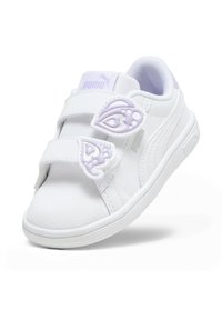 Baskets synthétiques blanches avec deux accents en forme de papillon violet et des bandes Velcro. Bout arrondi et semelle en caoutchouc texturé. Logo PUMA visible.