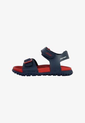 Sandalias en azul marino y rojo con suela de goma, que cuentan con correas ajustables y una plantilla texturizada. Diseño resistente al agua, adecuado para uso al aire libre.
