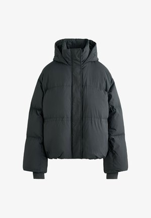 Temno siva puhovka z kapuco, prevelikim krojem, visokim ovratnikom in elastičnimi manšetami. Gladek, teksturiran material z nežnimi šivi.