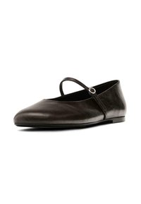 Black leather flat shoe with a rounded toe, narrow strap, and circular buckle detail. Smooth texture and low-profile design.