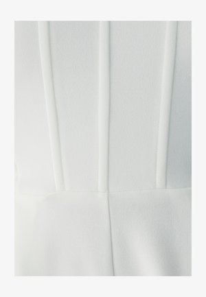 White garment featuring vertical seams, a smooth fabric texture, and a fitted design, emphasizing clean lines and minimal detail.