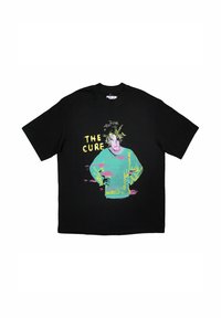 Black cotton t-shirt featuring a colorful graphic print of a person and the text "THE CURE" in yellow. Oversized fit with short sleeves.