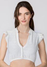 White cropped top with short ruffled sleeves, made from eyelet fabric featuring a floral pattern and a lace-trimmed neckline, button closure.