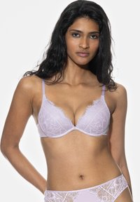 Lilac lace bra with a smooth cup design, featuring scalloped edging and thin adjustable straps, displayed on a model against a white background.