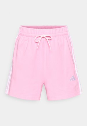 Pantalones cortos de color rosa claro hechos de tela suave, con una cintura elástica con cordón y franjas laterales blancas. Logotipo de Adidas en gris.