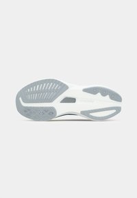 White athletic shoe sole with light gray accents. Features grooves and circles for traction. Textured rubber material, slightly curved design.