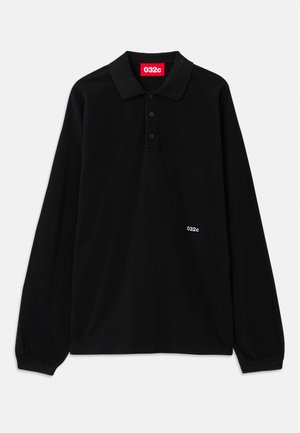 Black long-sleeve polo shirt with a classic collar, three buttons, and white brand logo "032c" on the left side. Made from soft cotton material.
