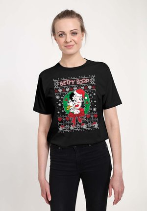 Black t-shirt featuring a colorful Betty Boop design with a Santa hat, surrounded by a festive border of hearts and snowflakes.