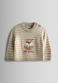 Beige triibuline kudum, ümar kaelus, puidust nööbiga detail, ja tikandiga jõulupudingu kujutis, millel on punane tekst "pudingu esimene jõul".