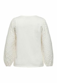 Hvit langermet topp med vevde blonder på ermene, rund hals og en avslappet passform. Myk bomullsdel.