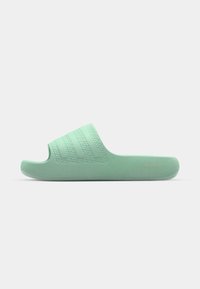 Green slide sandal made of textured rubber, featuring a wide strap with three embossed lines and a comfortable flat sole. Gold logo detail on side.