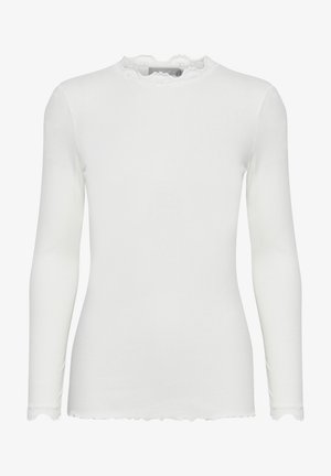 Top bianco a maniche lunghe realizzato in tessuto a coste, con un colletto in pizzo arricciato e polsini a onda, che garantisce una silhouette aderente.