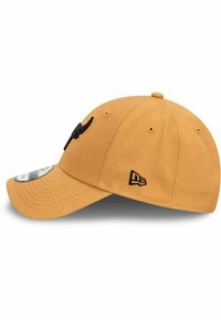 Yellow cotton baseball cap with a black embroidered logo, a curved visor, and ventilation eyelets on the sides.