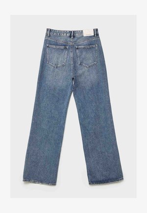 Light blue denim jeans with a loose, wide-leg design. Two back pockets, faded texture, and a waistband label at the back.