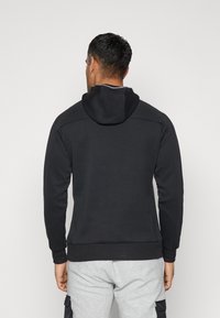 Black hooded sweatshirt with a smooth texture, ribbed cuffs, and hem. Features a plain back design, minimal stitching, and no visible logos.