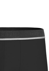 Black boxer briefs with a textured elastic waistband featuring a silver stripe and embossed lettering. Soft, smooth fabric designed for comfort.
