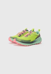 Bright green athletic shoes with pink laces, a textured upper, gray accents, and a light mint sole. Features a rugged tread for traction.