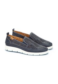 Zapatillas de lona de color marino con diseño floral cortado a láser, parte superior de cuero, suela de color claro, costuras en contraste y plantilla texturizada.