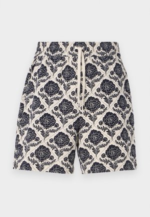 Calções estampados em creme com um padrão floral em azul marinho, apresentando uma cintura elástica e cordão, feitos de tecido leve.