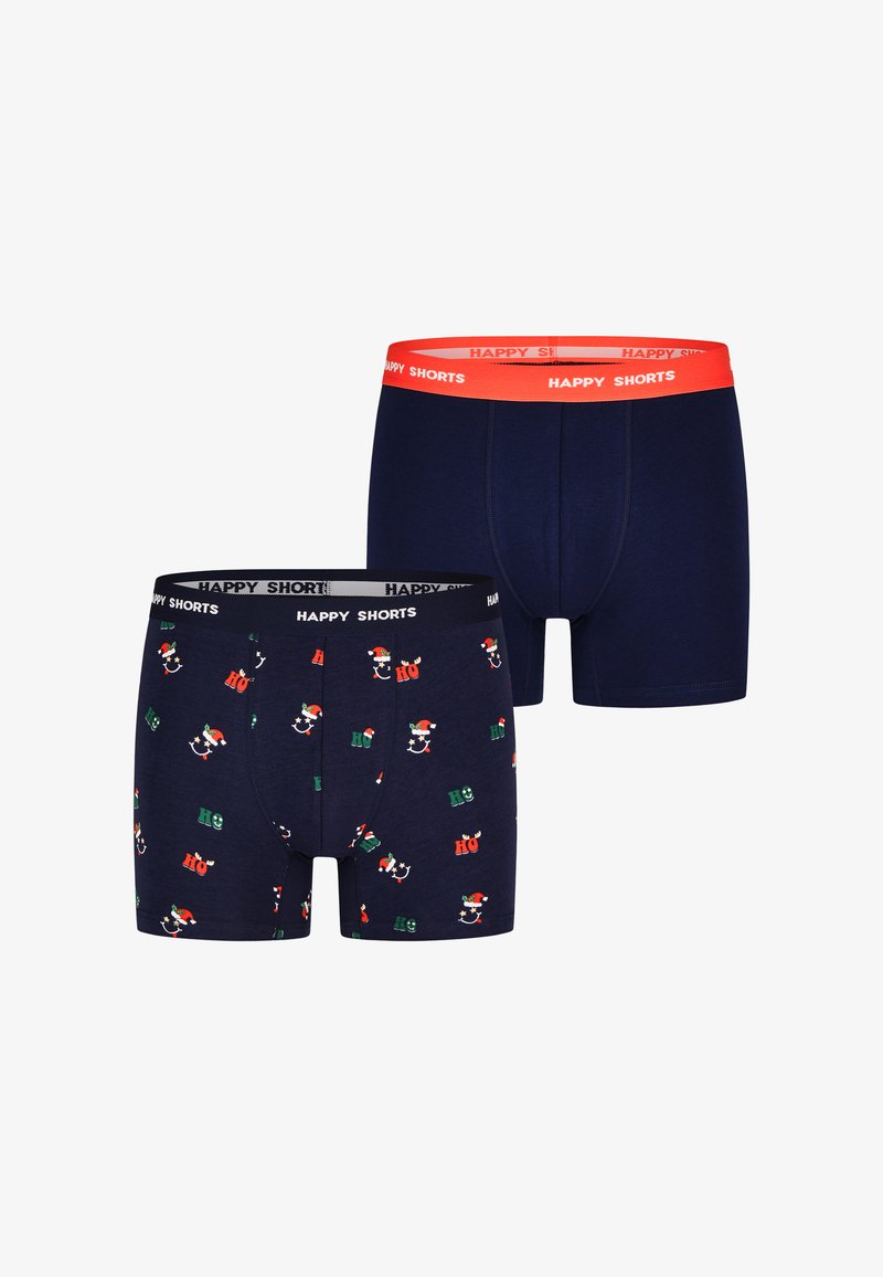 Twee paar marineblauwe katoenen boxers. De ene heeft een feestelijk patroon met een kerstman en "Ho"-tekst; de andere heeft een effen marineblauw ontwerp met een oranje tailleband.