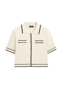 Cardigan a maniche corte, crema, con accenti neri, caratterizzato da un colletto, due tasche sul petto e bottoni frontali. Materiale a maglia texturizzato.