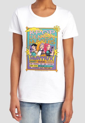 White t-shirt with colorful K-pop Demon Hunters graphic showing three animated female characters and text listing names and a Summer Slay Festival.