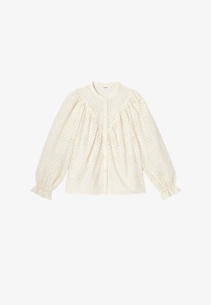 Blouse à manches longues couleur crème avec broderie ajourée, col rond, boutonnage sur le devant, épaules bouffantes et poignets élastiques ornés d'un volant.