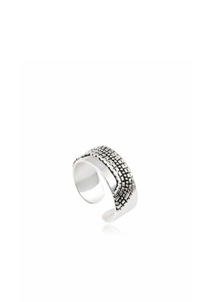 Bague manchette ouverte en argent avec motif texturé de points carrés sur la surface supérieure, intérieur poli lisse, reflétant la lumière sur fond blanc.