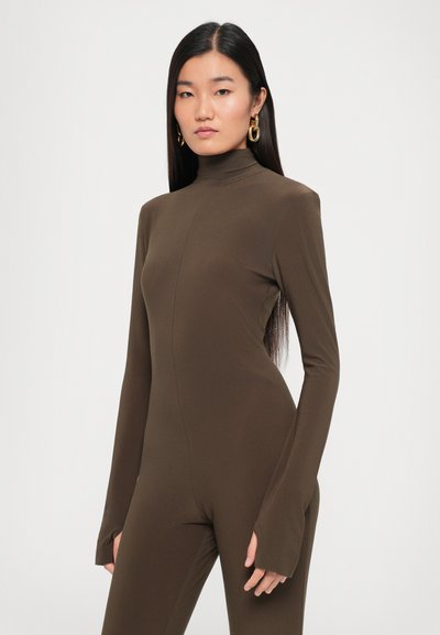 Brown long-sleeve jumpsuit with a high neck and flared cuffs, made of smooth fabric, featuring a fitted design and minimal seams.