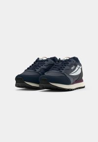 Navy blue athletic shoes with synthetic and mesh materials, featuring a white logo, purple and gray accents, textured rubber outsole.