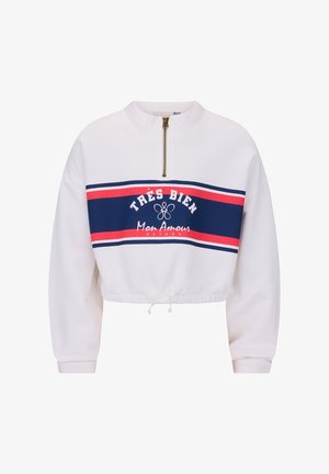 Biała krótka bluza z poziomymi paskami w kolorze granatowym i czerwonym, złoty zamek błyskawiczny na pół, elastyczny dół i napis "Très Bien Mon Amour" z przodu.