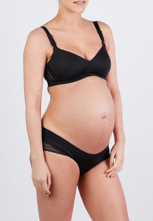 Soutien-gorge de maternité noir avec bretelles réglables, accents en dentelle et finition lisse. Sous-vêtements de maternité noirs avec bord en dentelle et taille douce.