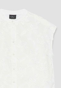 White sleeveless blouse with floral embroidered pattern and front button closure.