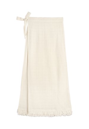 Jasnokremowa spódnica robocza z zapięciem na boczną kokardę i frędzlami, wykonana z fakturowanej tkaniny.