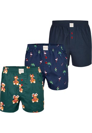 Boxer shorts in green and navy, featuring festive patterns with bears, flamingos, and Christmas accents, crafted from soft fabric with elastic waistbands.