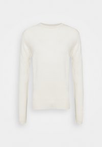 Ljuskräm-färgad tröja gjord av mjukt material, med långa ärmar och rund halsringning. Slät textur med ribbade muddar och nederkant.