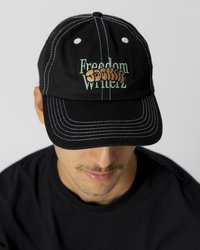 Black baseball cap with white stitching, featuring "Freedom Writerz" embroidered in orange and green. Curved brim and adjustable strap.