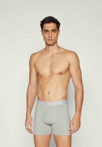 Boxer-cuir grises en coton avec une ceinture douce étiquetée "GAP", arborant une silhouette ajustée et une texture lisse.