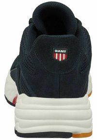 Black mesh and suede sneaker with white midsole, rubber outsole, and red accents. Features a GANT logo patch on the heel.