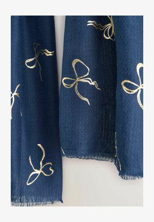 Marineblå tørklæde lavet af tekstureret stof, med guldfarvede sløjfemønstre og frynsede kanter.