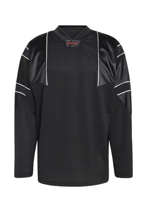 Černý dres s dlouhým rukávem s texturou z hálky, kontrastní bílé pruhy na rukávech a výstřihem do V; červené logo značky.