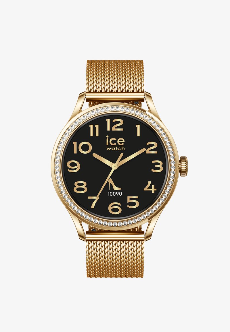 Náramkové hodinky se zlatým síťovaným páskem, černým ciferníkem, zlatými arabskými číslicemi, křišťálovým rámečkem a logem s ikonou vysokého podpatku na pozici 7 hodin.