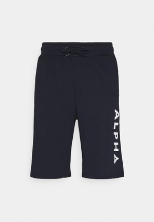 Shorts de sport bleu marine en tissu doux, avec une taille élastique à cordon de serrage et un logo blanc "ALPHA" imprimé verticalement sur la jambe gauche.