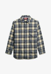 Chemise à manches longues à carreaux beige et bleu marine, fabriquée en tissu flanelle. Présente une fermeture par bouton et une poche poitrine, avec un logo sur la poche.