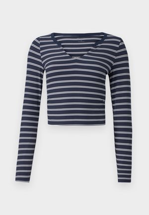 Navyblauw cropped longsleeve top met witte horizontale strepen en een V-halslijn. Gemaakt van ribbelstof, met een aansluitend ontwerp.